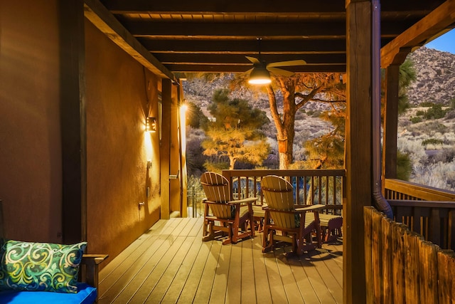 wooden deck featuring a ceiling fan