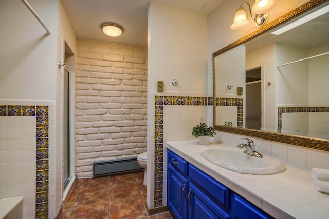 bathroom with a baseboard heating unit, toilet, wainscoting, a stall shower, and vanity