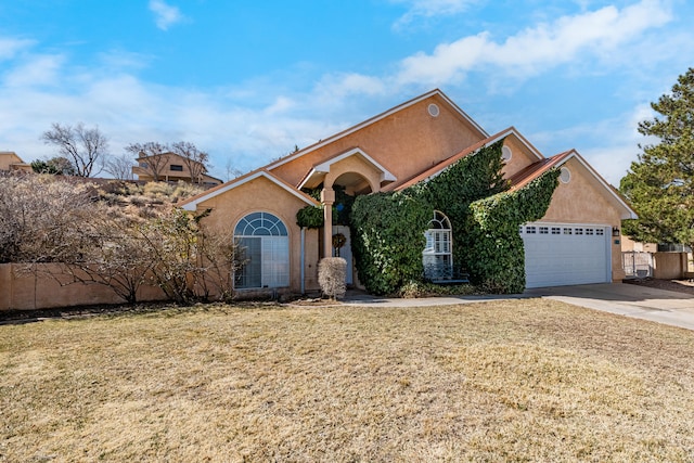 view of front of home featuring a front yard, a garage, driveway, and stucco siding