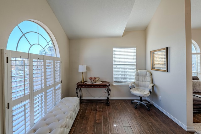 living area featuring baseboards and wood finished floors