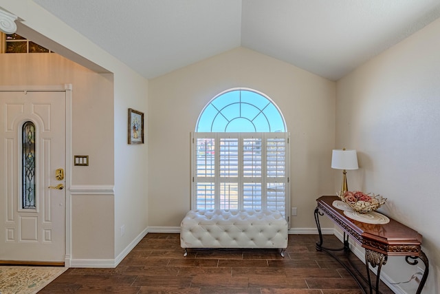 foyer entrance with vaulted ceiling, baseboards, and dark wood-style flooring