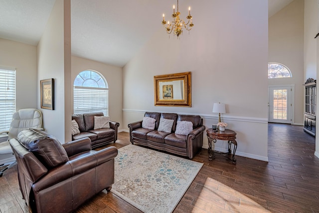 living room with high vaulted ceiling, a healthy amount of sunlight, and wood finished floors