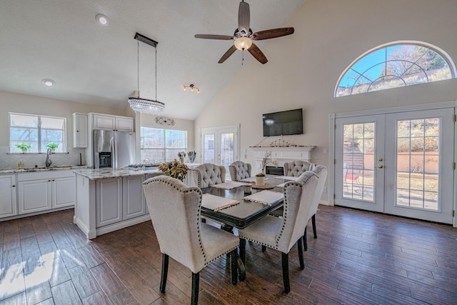 dining space with french doors, high vaulted ceiling, dark wood-type flooring, and a ceiling fan