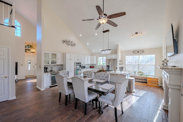 dining space with baseboards, wine cooler, dark wood-style flooring, and vaulted ceiling