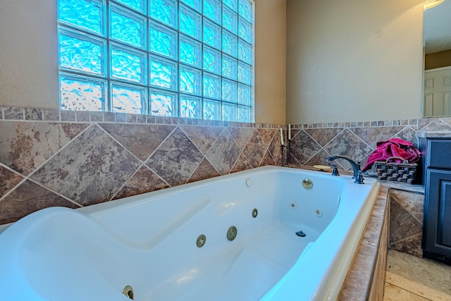 full bathroom featuring a jetted tub and vanity