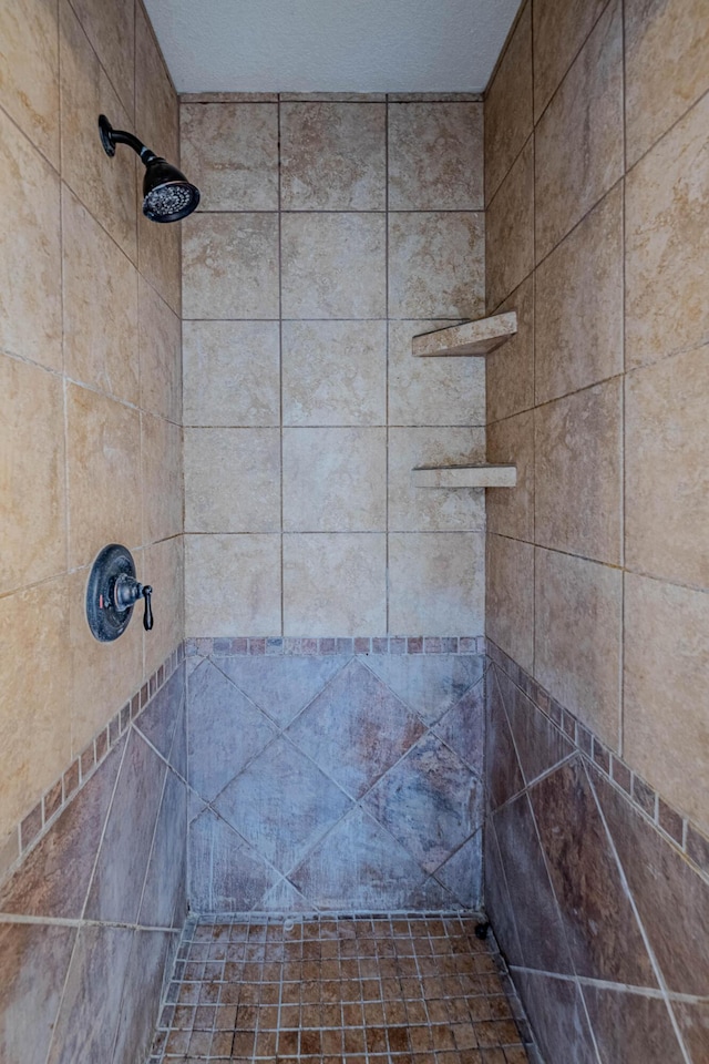 bathroom with a tile shower