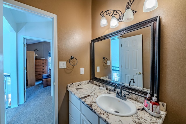 bathroom with vanity and a textured wall