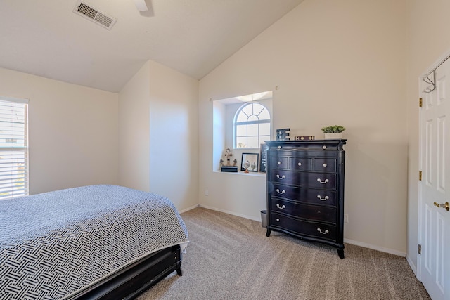 bedroom with visible vents, baseboards, carpet, and vaulted ceiling