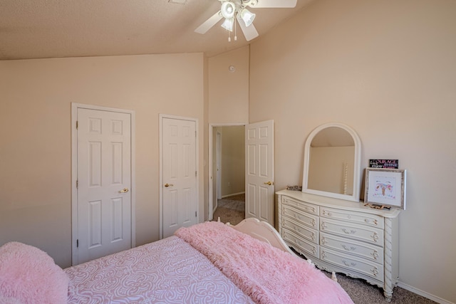 bedroom featuring a ceiling fan, baseboards, carpet floors, and high vaulted ceiling