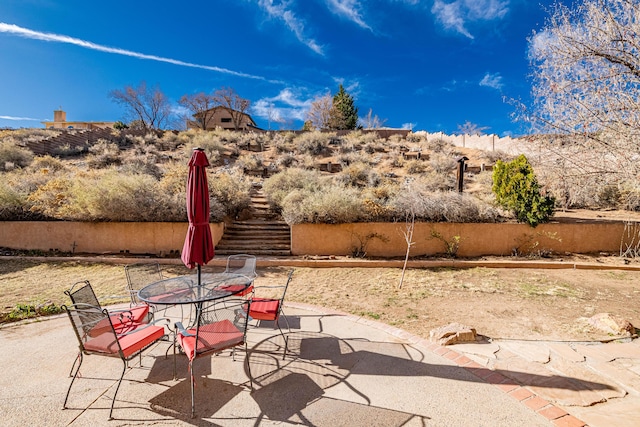 view of patio featuring stairway and outdoor dining area