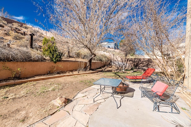 view of patio / terrace featuring a fire pit and a fenced backyard