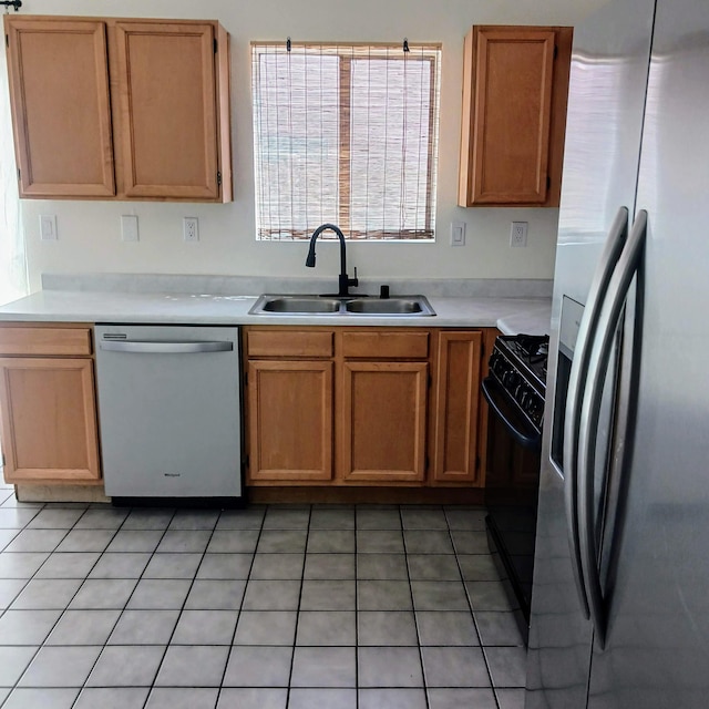 kitchen featuring light tile patterned floors, appliances with stainless steel finishes, light countertops, and a sink