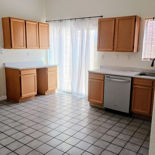 kitchen featuring dishwasher, light countertops, and a sink