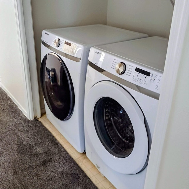 clothes washing area with light tile patterned flooring and washer and dryer