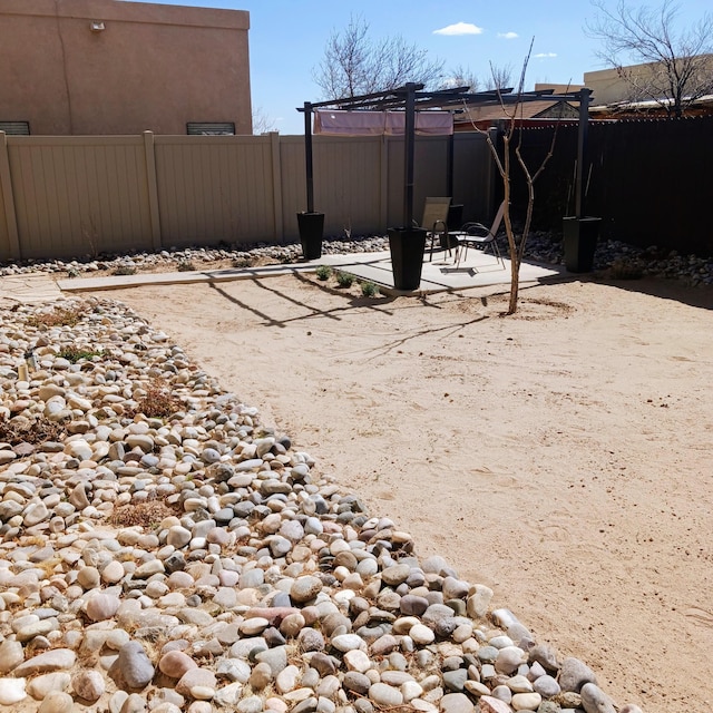 view of yard featuring a patio and fence