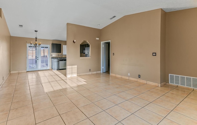 unfurnished living room with lofted ceiling, light tile patterned flooring, baseboards, and visible vents