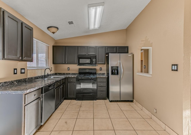 kitchen with visible vents, black appliances, a sink, light tile patterned floors, and lofted ceiling