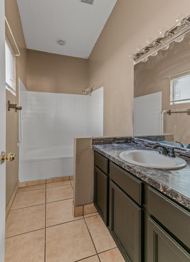 full bath featuring vanity, visible vents, walk in shower, tile patterned flooring, and a textured ceiling