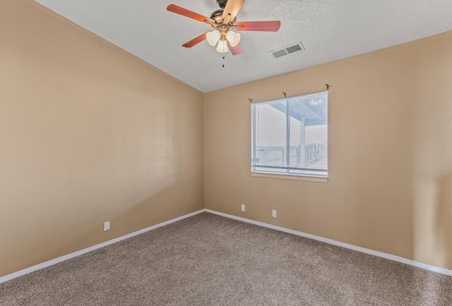 carpeted empty room with baseboards, visible vents, ceiling fan, vaulted ceiling, and a textured ceiling