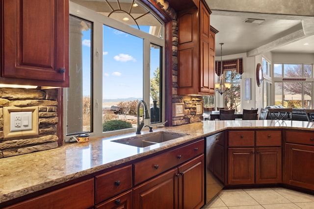 kitchen with visible vents, a sink, light stone counters, light tile patterned floors, and dishwashing machine