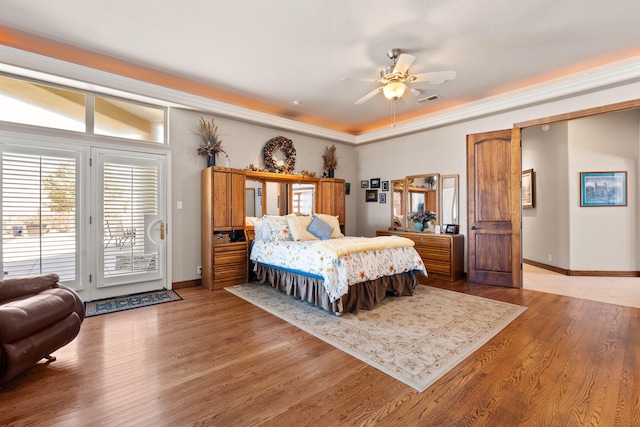 bedroom featuring access to exterior, visible vents, baseboards, and wood finished floors