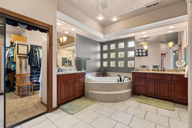 full bath with a ceiling fan, visible vents, two vanities, a sink, and a garden tub