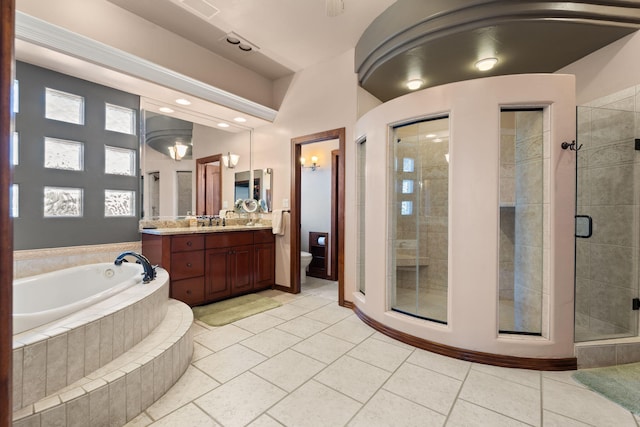 bathroom featuring vanity, a bath, a stall shower, tile patterned floors, and toilet