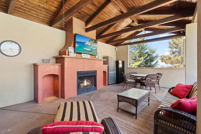 view of patio / terrace featuring outdoor dining space and an outdoor living space with a fireplace