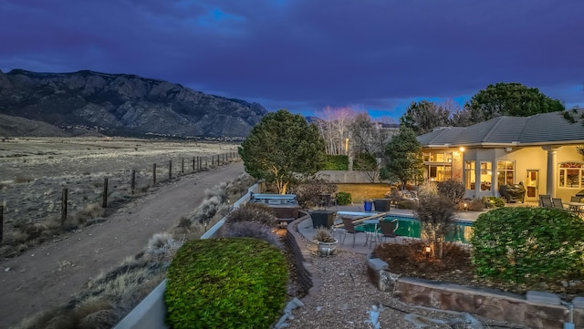 exterior space with a patio, a mountain view, a fenced in pool, and fence