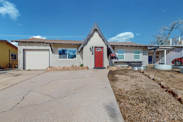 view of front facade featuring driveway, a garage, and roof with shingles