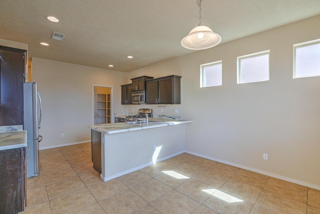 kitchen with a wealth of natural light, visible vents, stainless steel appliances, a peninsula, and light countertops