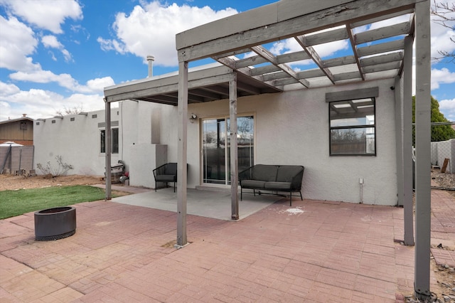 view of patio / terrace with fence, a fire pit, and a pergola