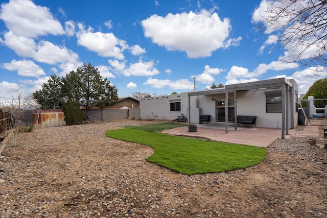 rear view of house with a patio area, a fenced backyard, and stucco siding