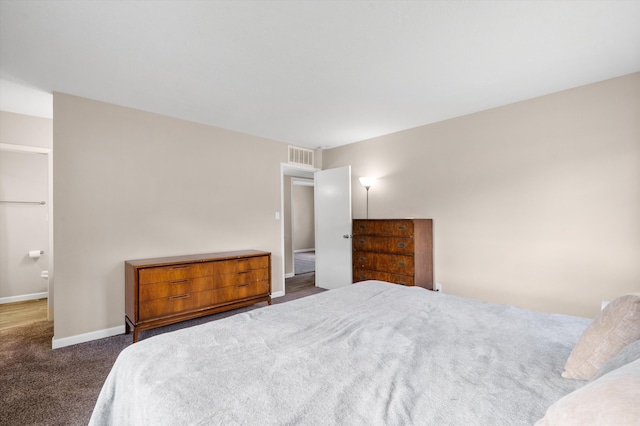 carpeted bedroom featuring baseboards and visible vents