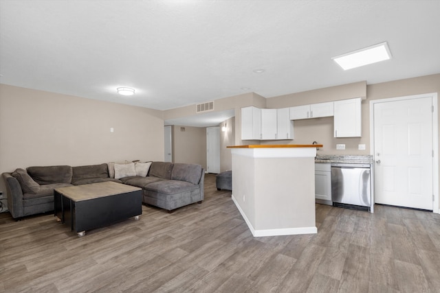 living area featuring visible vents and light wood-style flooring