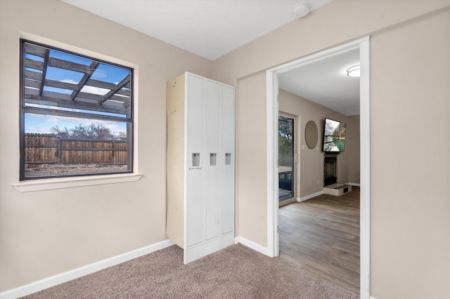 carpeted spare room with baseboards