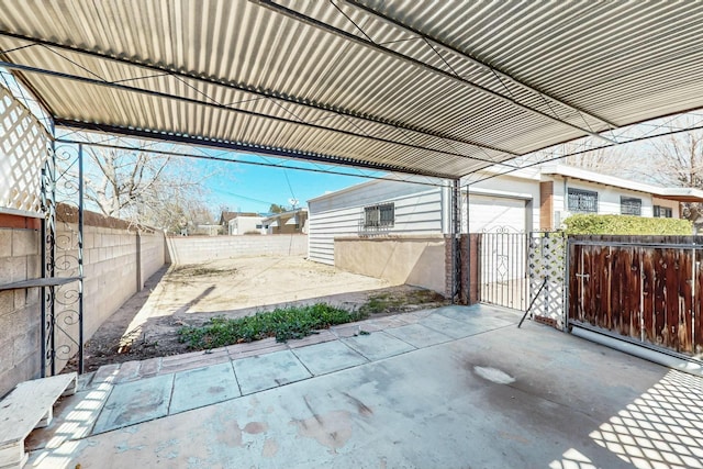 view of patio with an outdoor structure and fence