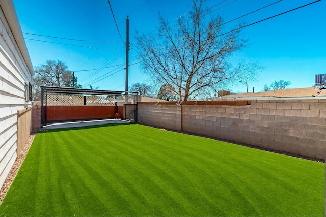 view of yard with a fenced backyard