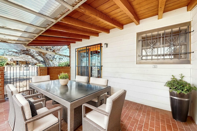 view of patio with outdoor dining area and fence