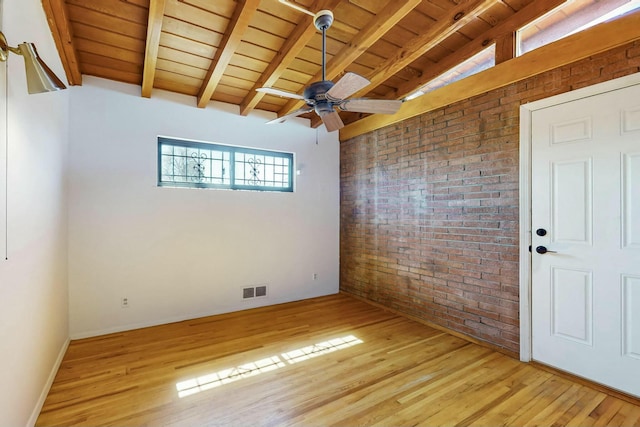 empty room featuring light wood-type flooring, wood ceiling, brick wall, and visible vents