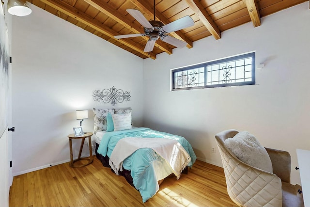 bedroom featuring wood finished floors, baseboards, lofted ceiling with beams, ceiling fan, and wood ceiling