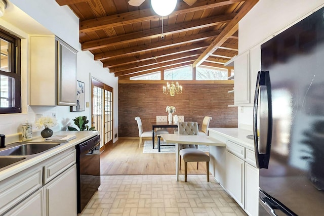 kitchen with black appliances, light countertops, brick floor, and wooden ceiling