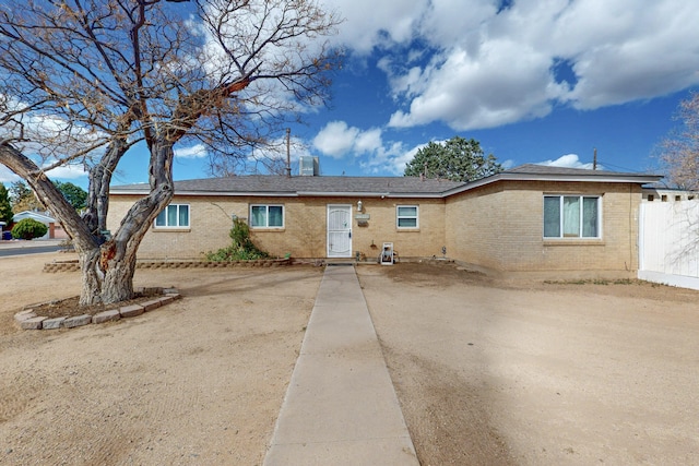 ranch-style house with brick siding and fence