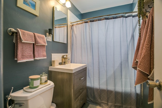 bathroom featuring curtained shower, toilet, and vanity