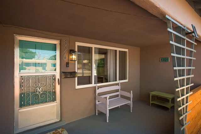 entrance to property featuring stucco siding