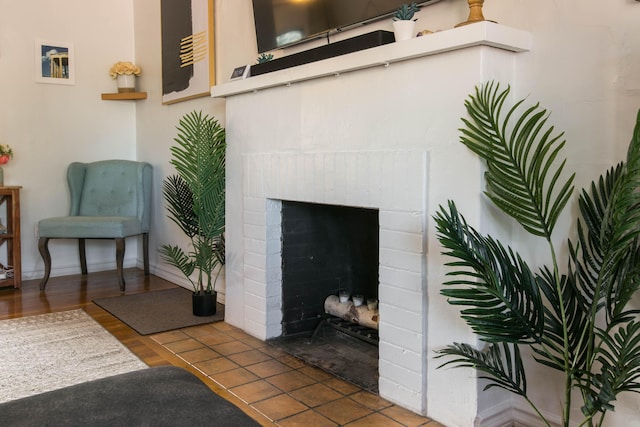 living room featuring a fireplace and baseboards