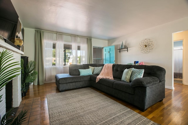 living area with baseboards and wood-type flooring