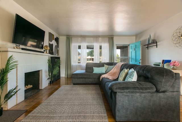 living area with a brick fireplace