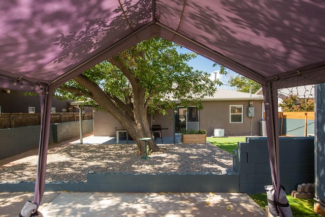 view of patio featuring fence