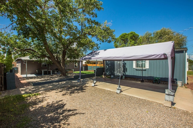 view of front of property with a patio and fence